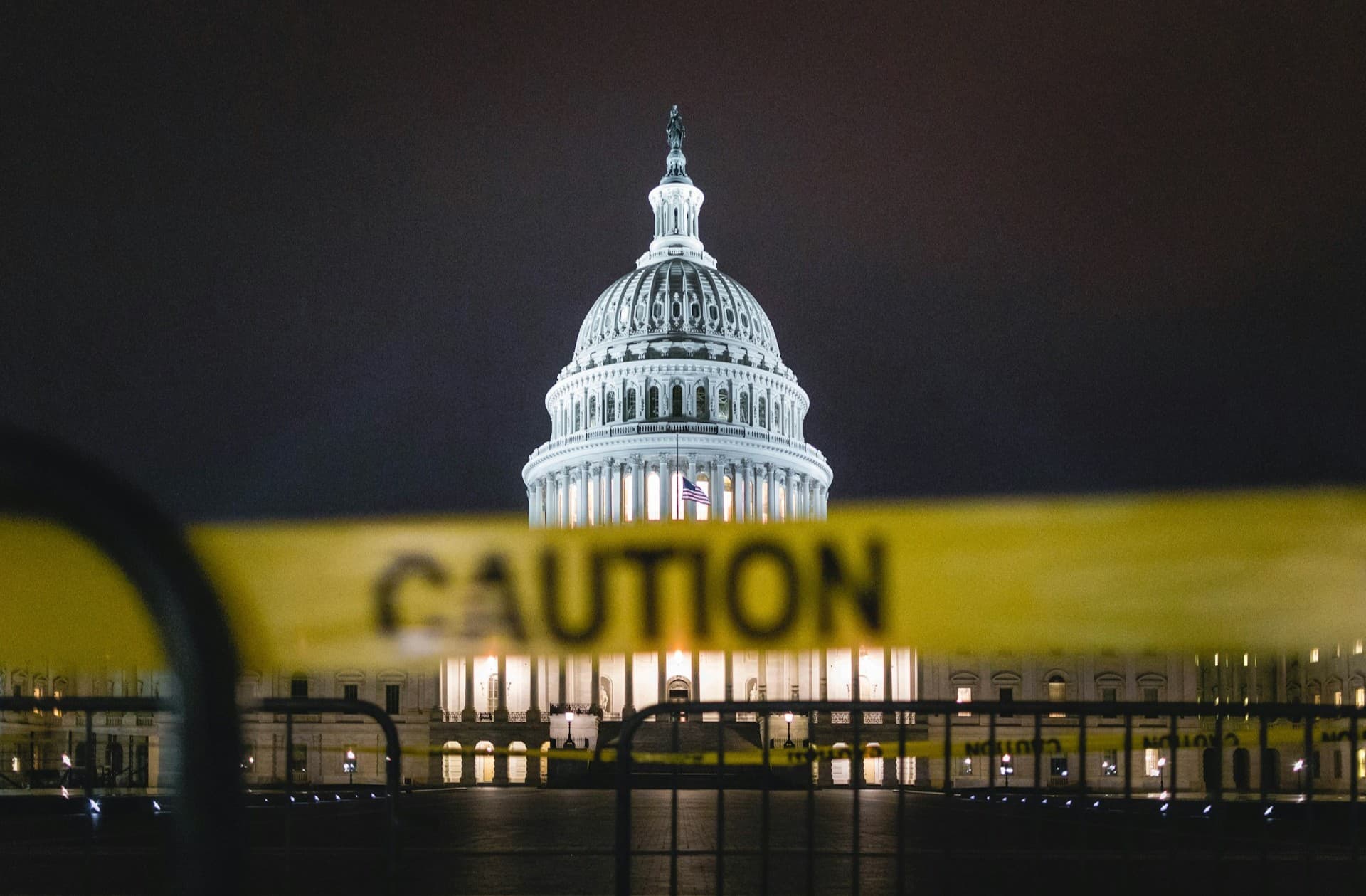Caution tape with US Capitol building in the background.