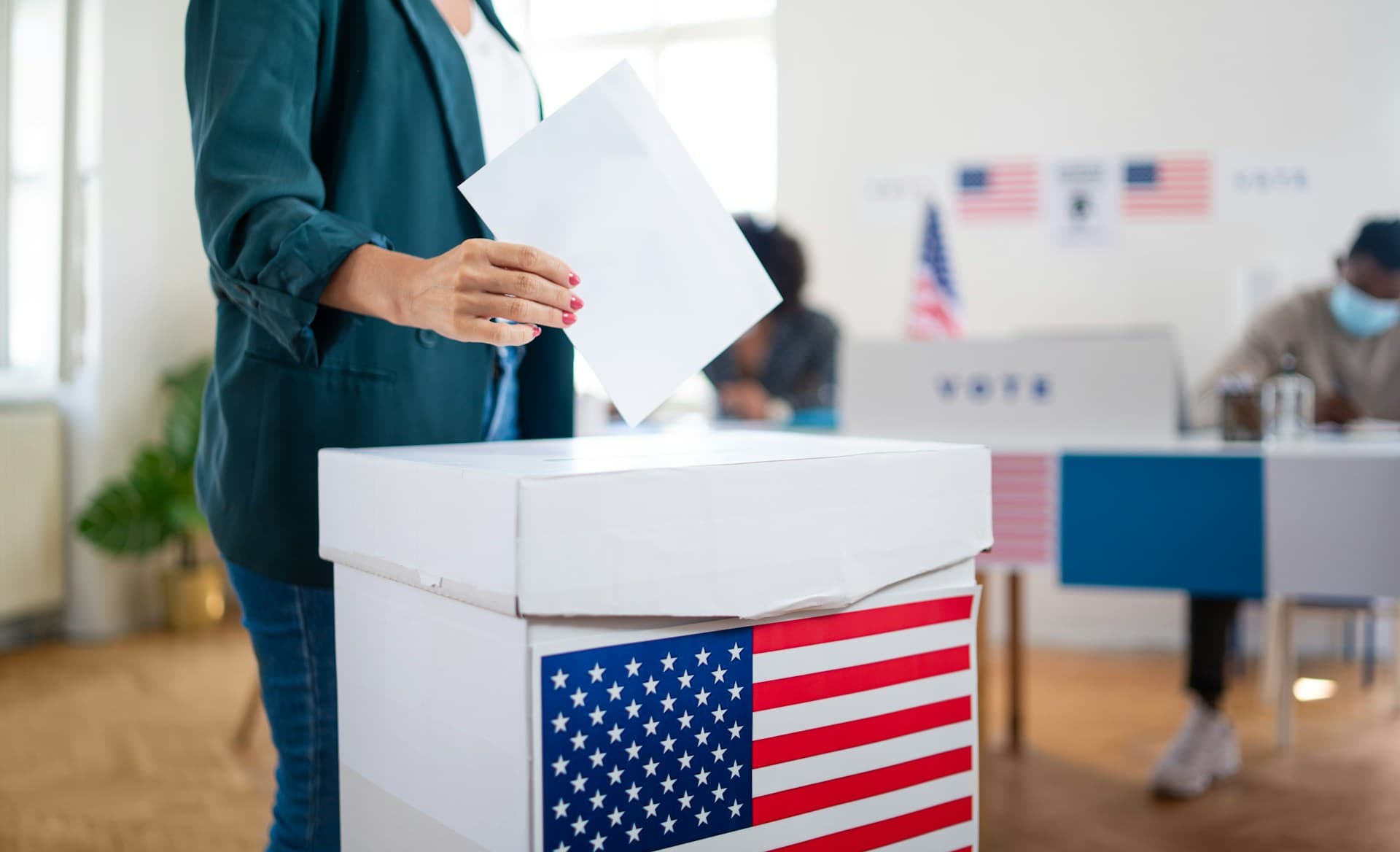 Woman putting ballot in ballot box.